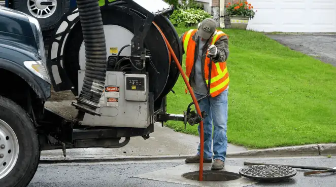 Technician using specialized drainage equipment for sewer line cleaning and foundation protection in Lakeland, FL