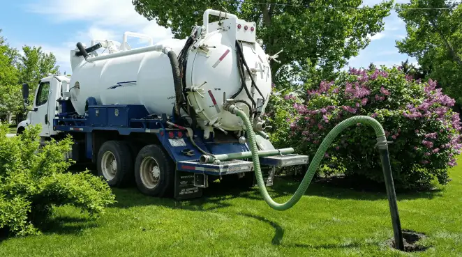 Professional vacuum truck performing residential drainage and septic maintenance in Lakeland, FL