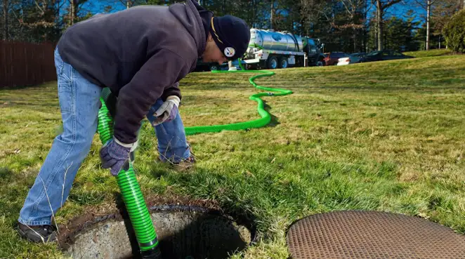 Service technician performing residential septic pumping and drainage maintenance in Lakeland, FL
